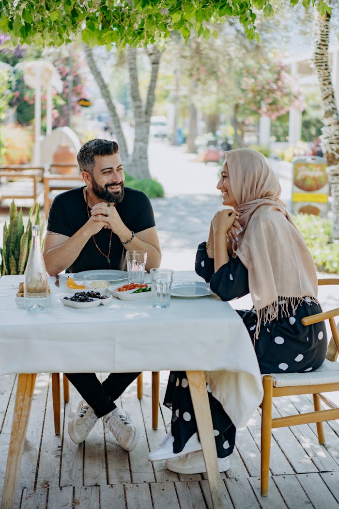 contact-img A couple enjoying breakfast at an outdoor cafe, sharing smiles and conversations.