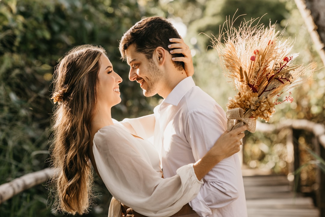 man-in-white-dress-shirt-holding-brown-flower-bouquet-ac5-efhq7fs
